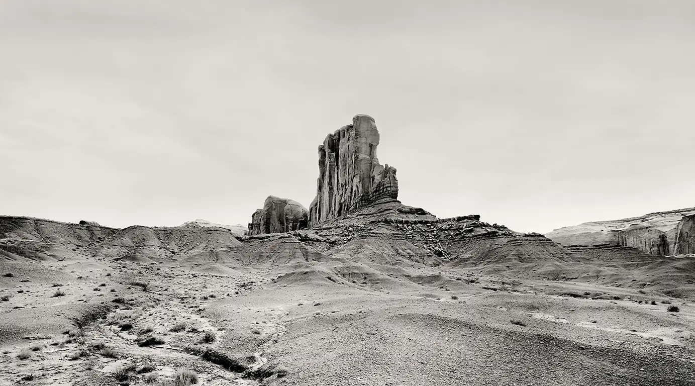 black-and-white photograph of Elephant Butte in Monument Valley, captured as a towering cliff reminiscent of a ship’s bow